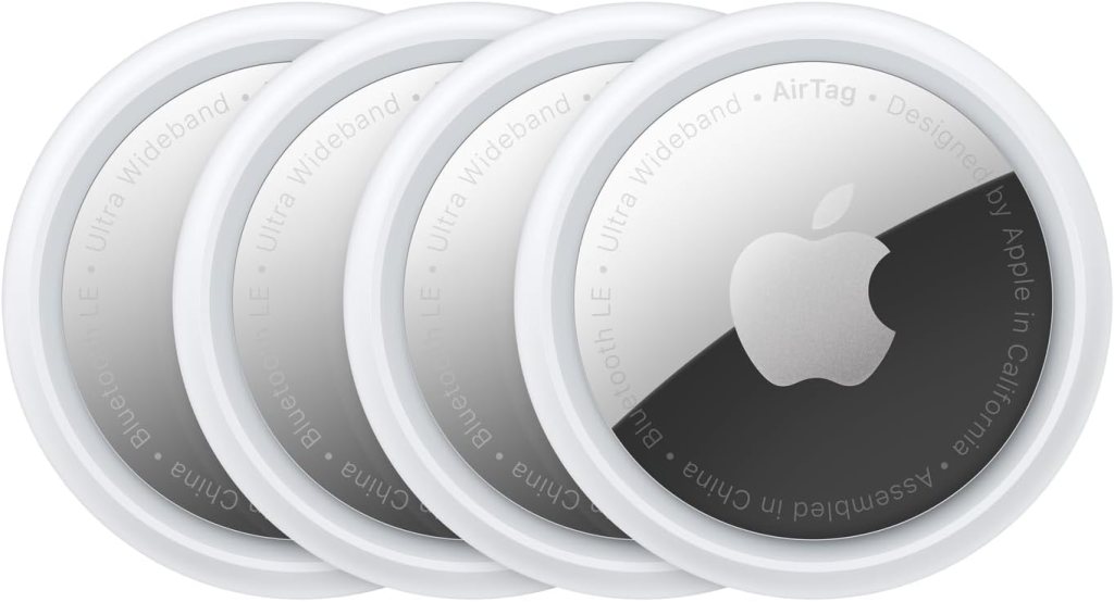 A pack of four Apple AirTags, designed for tracking and finding items using Bluetooth technology.