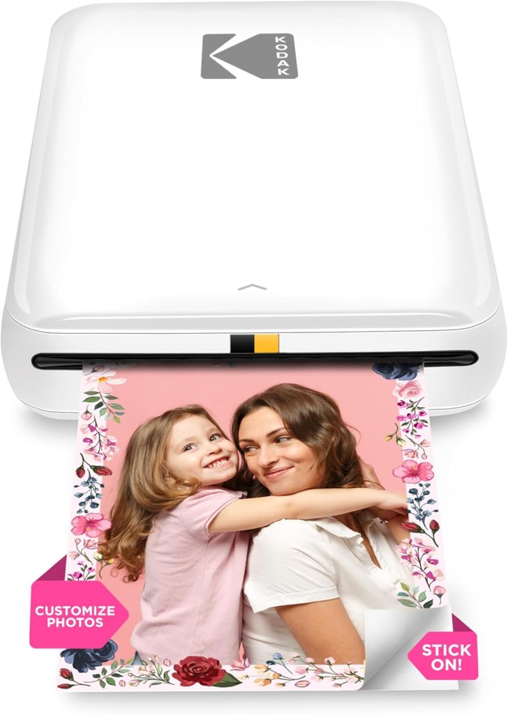 Kodak wireless photo printer with a photo of a smiling girl hugging a woman, surrounded by a floral border and a label that says 'CUSTOMIZE PHOTOS'.