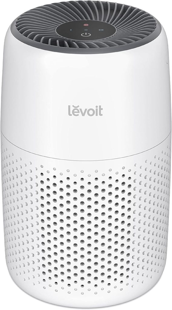 A Levoit Core Mini Air Purifier with a sleek white design, featuring a circular top and perforated base for air intake.
