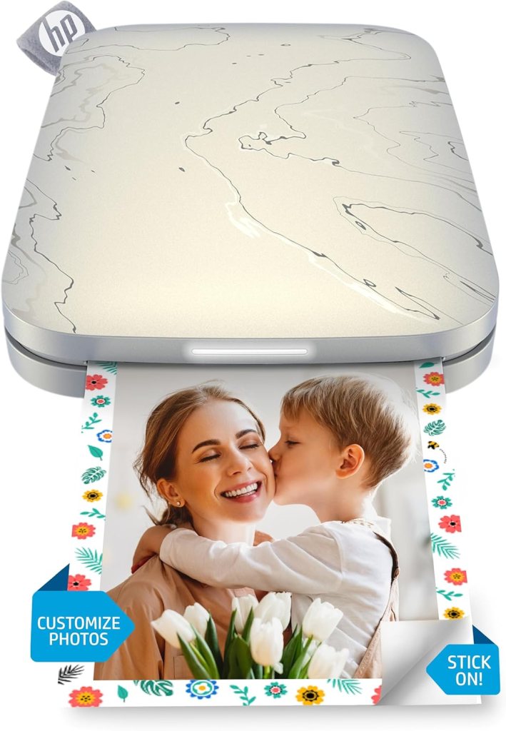 Portable photo printer with a customized floral design, printing a photo of a woman and a child sharing a joyful moment.